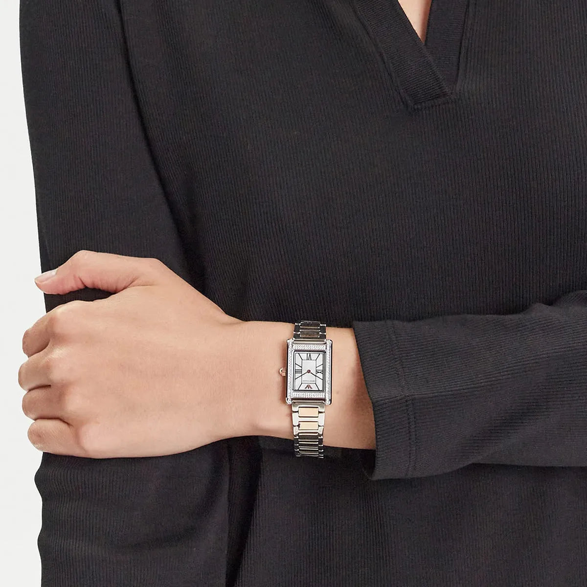 Emporio Armani Genni two-tone watch worn on wrist showing white dial and crystal-set rectangular case