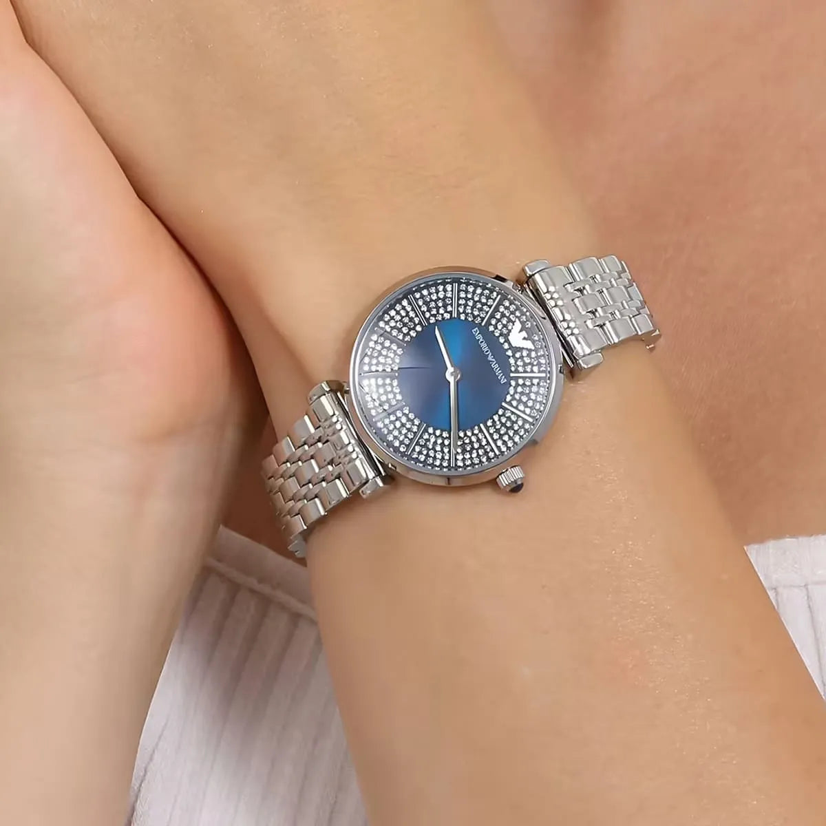 Emporio Armani Gianni T-Bar women's watch worn on wrist showing blue crystal dial and silver bracelet