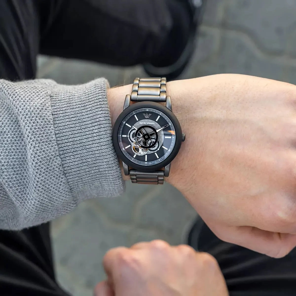 Emporio Armani Luigi Meccanico skeleton watch worn on wrist with metal strap