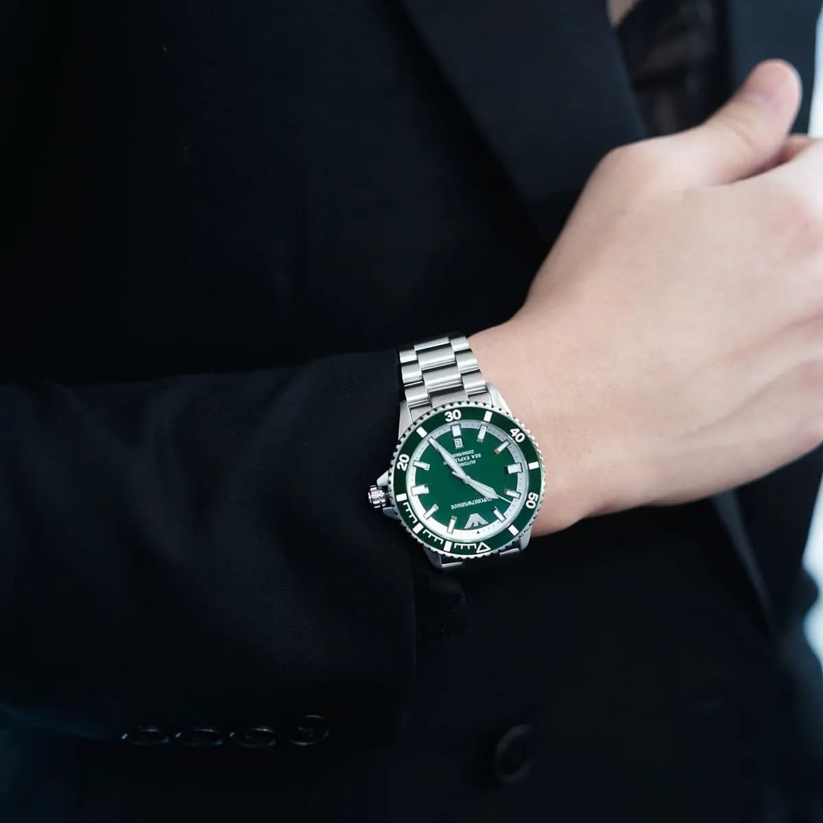 Sea Explorer watch worn on wrist showing green dial and stainless steel bracelet