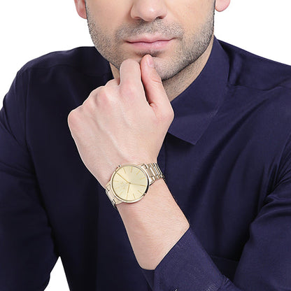 AX2707 three-hand watch on wrist showing minimalist dial and gold-tone design