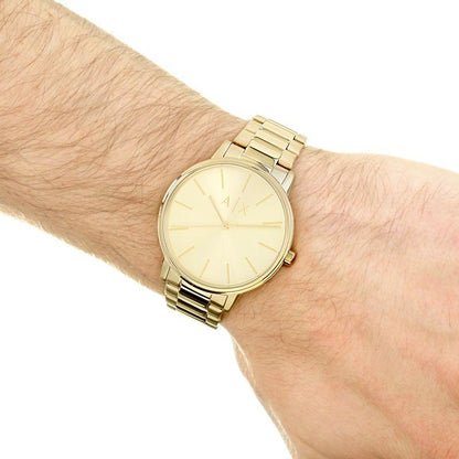 Armani Exchange AX2707 gold-tone watch worn on wrist