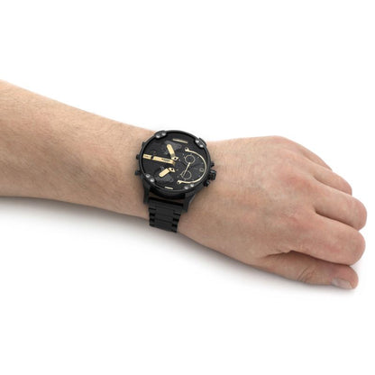 Black Diesel chronograph watch with gold-tone subdials worn on men's wrist with black bracelet