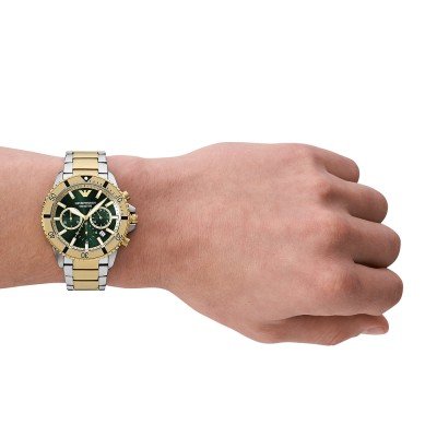 AR11586 chronograph worn on wrist showing green dial and two-tone design