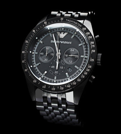 Emporio Armani Tazio AR5989 chronograph watch with matte black dial and steel bracelet on black background