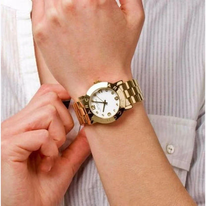Marc By Marc Jacobs Amy watch worn on wrist, showing gold-tone bracelet and white dial