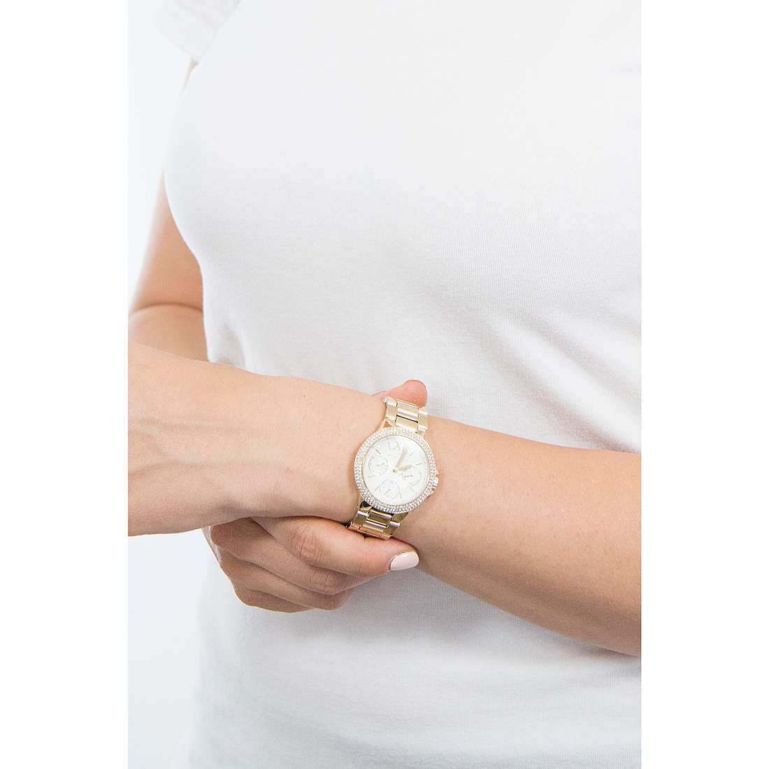 Michael Kors Camille watch worn on wrist with white dial and gold-tone case