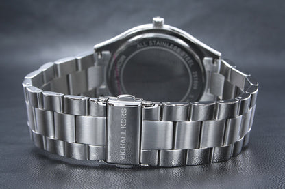 Michael Kors Runway watch case back showing stainless steel and Michael Kors branding
