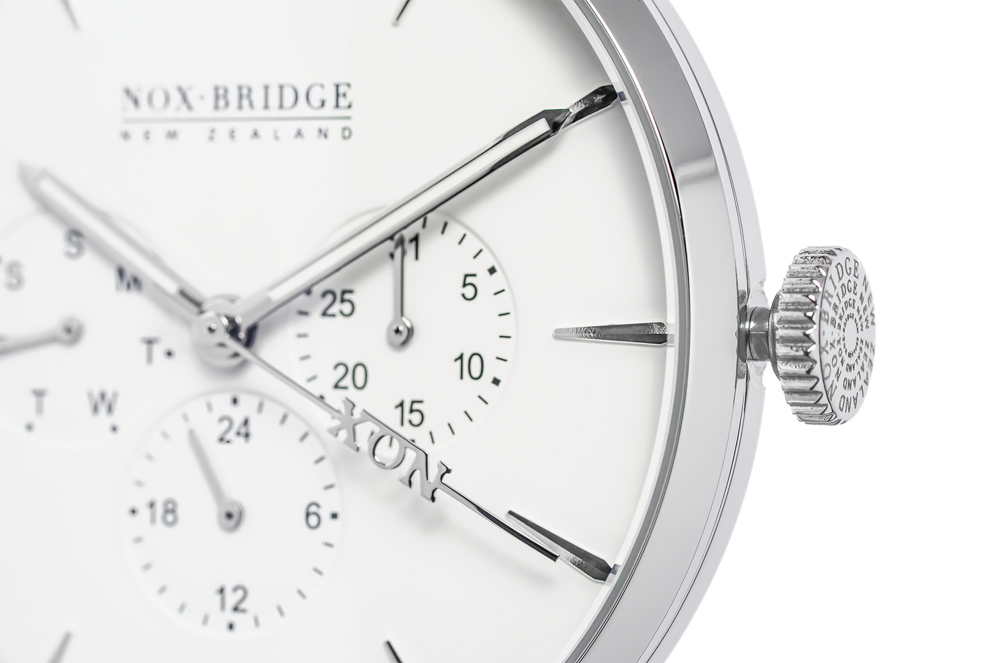 Close-up of Alcyone watch dial showing subdials, applied indices, and textured crown