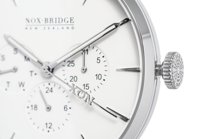 Close-up of Alcyone watch dial showing subdials, applied indices, and textured crown