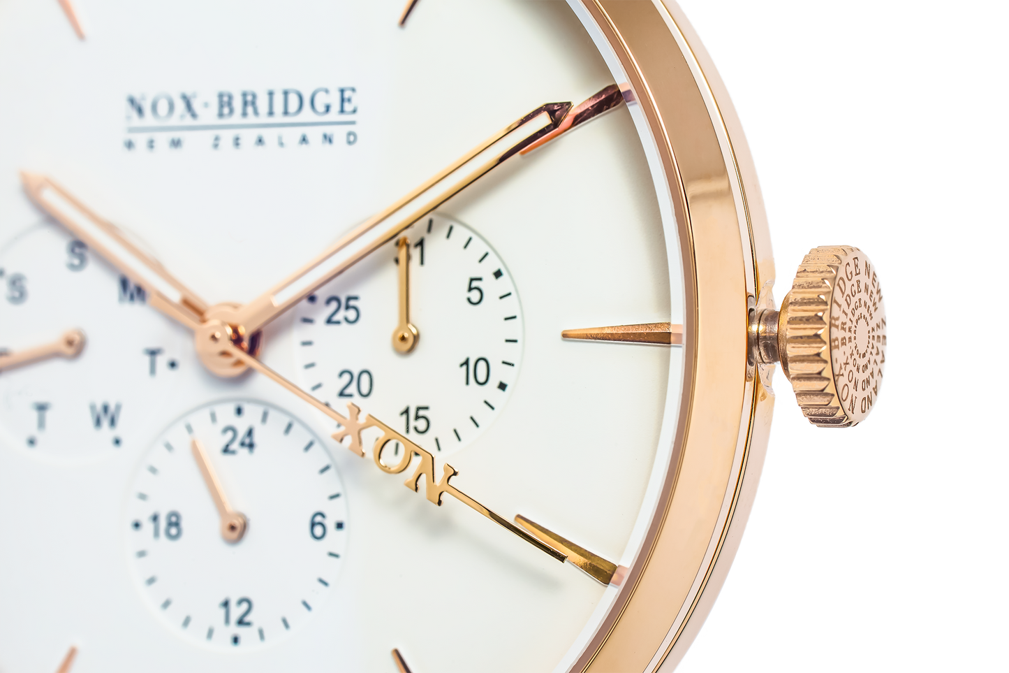Close-up of rose gold case, cream dial with dual subdials, and crown detail