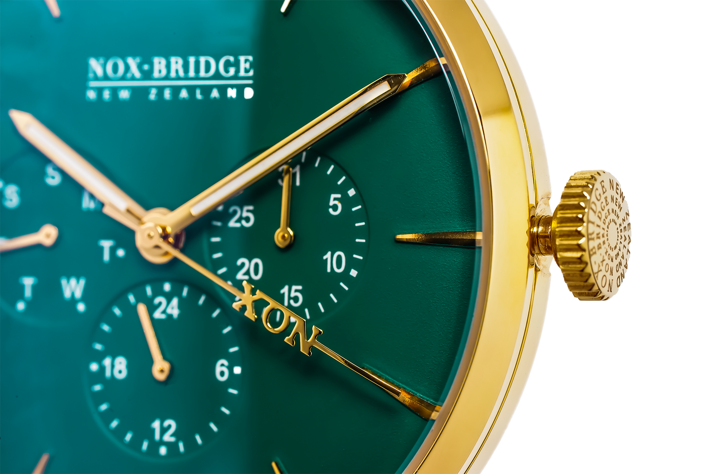 VG36 dial detail showing chronograph subdials, gold hands, and green face