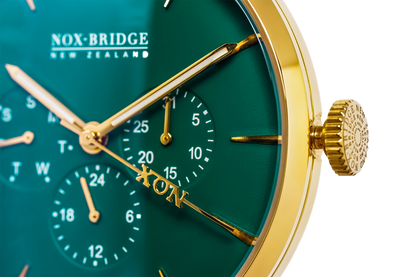 VG36 dial detail showing chronograph subdials, gold hands, and green face