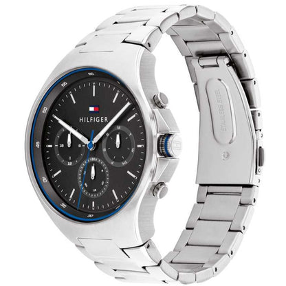 Tommy Hilfiger 1792054 three-quarter view showing silver bracelet and black dial with blue bezel