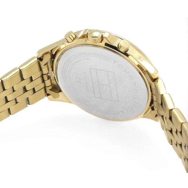 Gold-tone case back of Tommy Hilfiger women's watch showing engraved branding