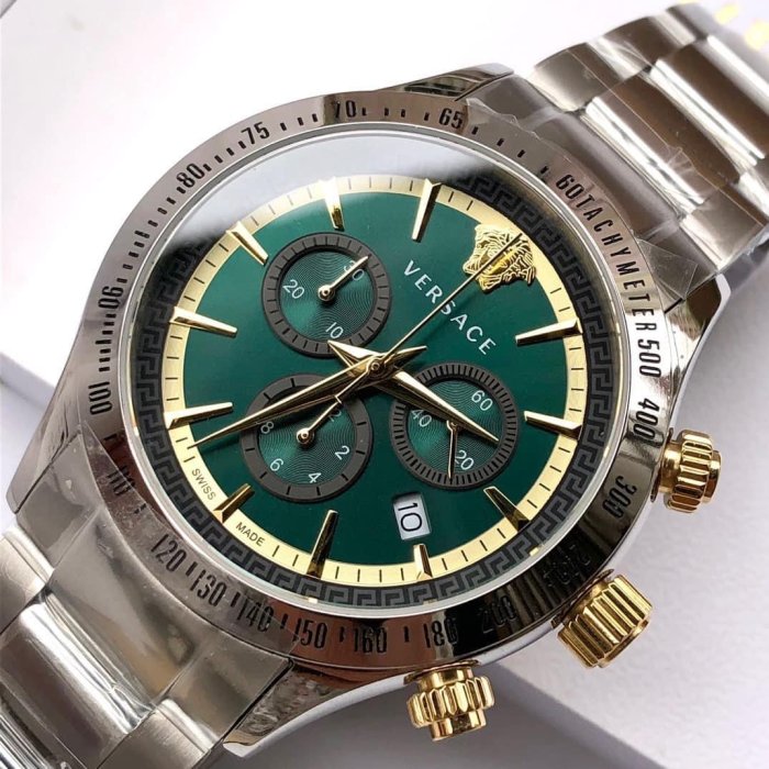 Angled view of Versace Classic Chronograph showing green dial with Medusa logo, three subdials, and steel bracelet