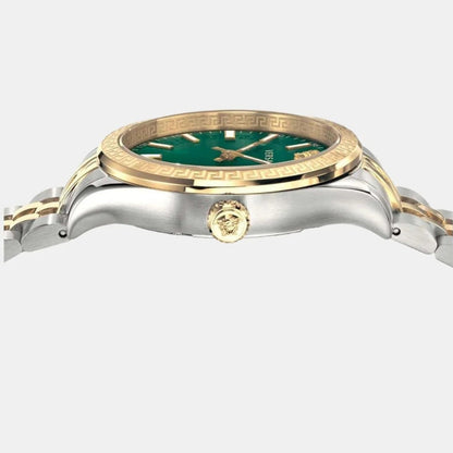 Close-up of Versace Hellenyium green dial with hour markers, hands, and gold Greek key bezel detail